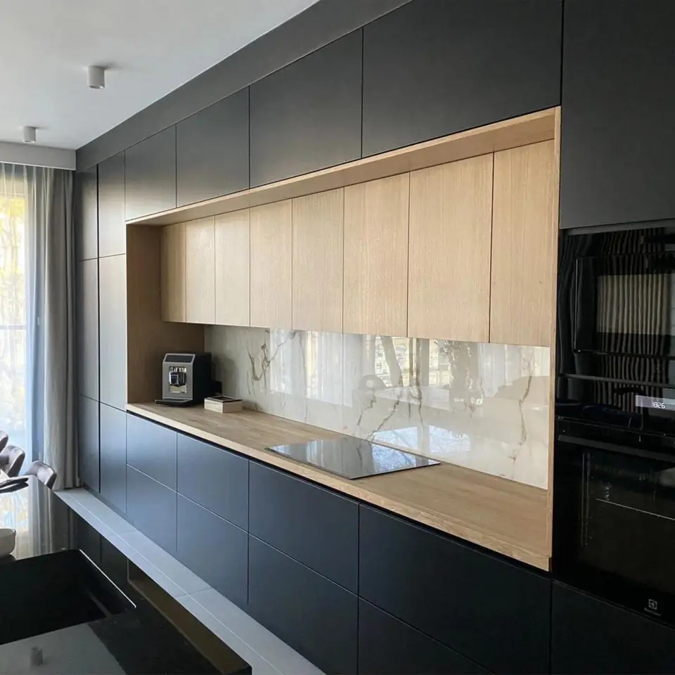 Matt black handleless kitchen with an oak feature niche