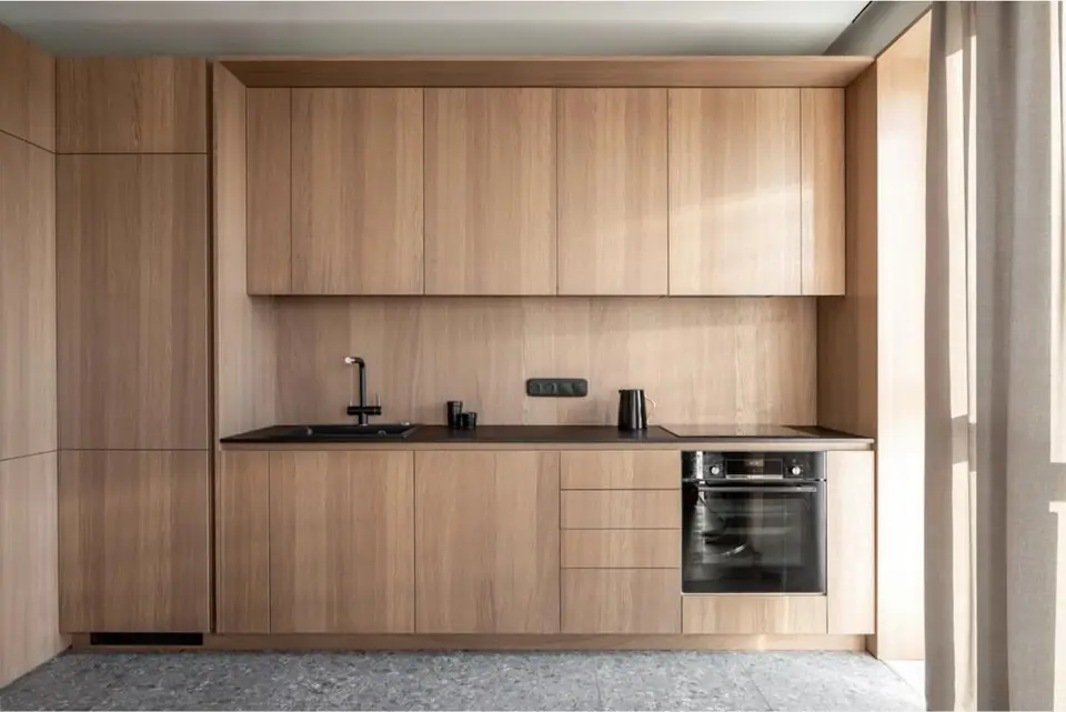 Handleless oak veneer kitchen with integrated oven