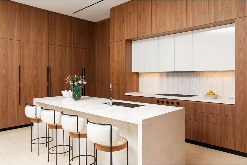 Walnut veneer kitchen with white stone island
