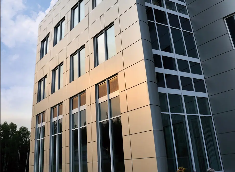 Commercial building clad in metallic fluorocarbon fibre cement panels