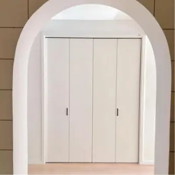 Bi-fold pantry doors in an arched opening